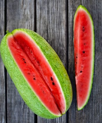 Ripe sweet slice of watermelon on a rustic background. Close up, top view