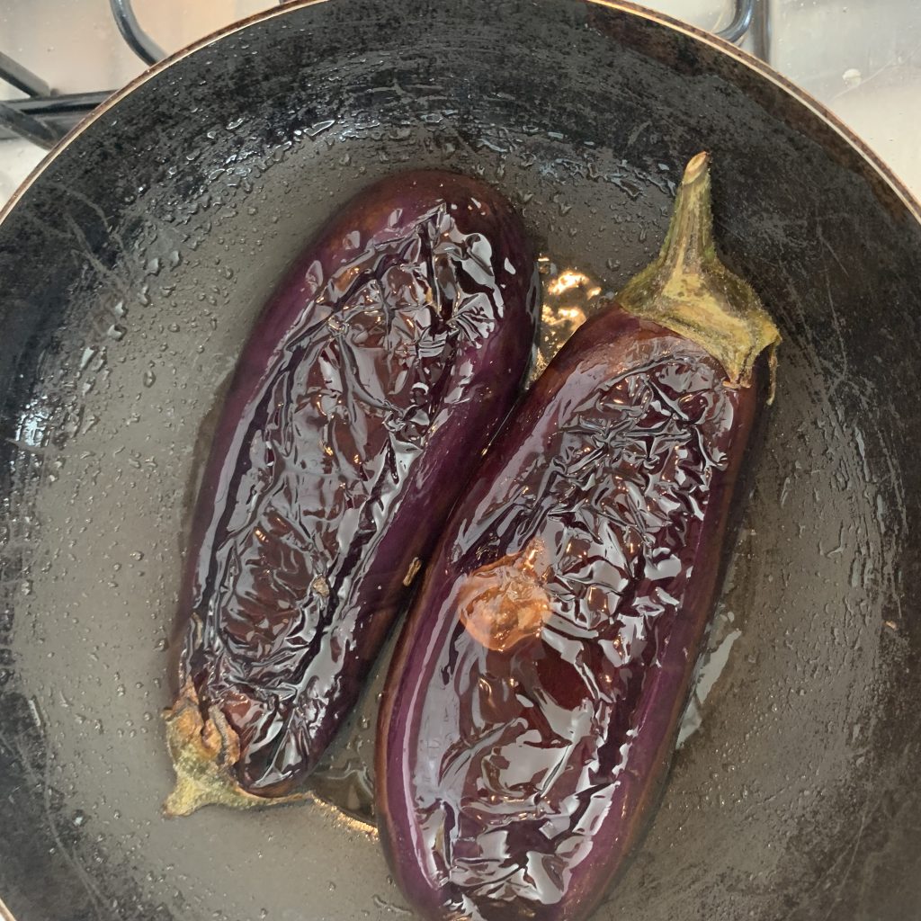 Two aubergines in a frying pan